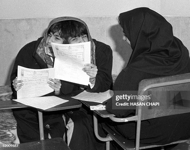 This file photo dated 23 April 1993 shows Iranian sisters Laleh and Ladan Bijani taking their university entrace examination in Tehran. The historic...