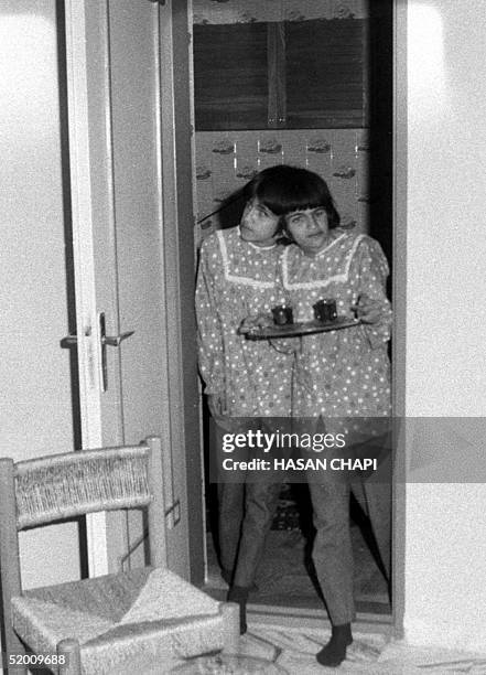 This file photo dated 10 October 1989 shows Iranian sisters Laleh and Ladan Bijani serve tea in their adoptive father's house in Karaj, 46km from...