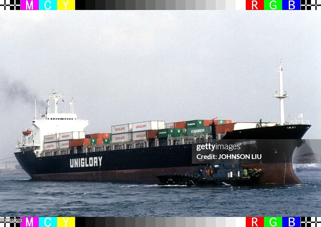 A tug boat pilots the Uni-order, a Panama-register