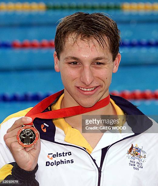 Australia's Ian Thorpe displays his gold medal after setting a new world record in the 200m men's freestyle on the third day of the Pan Pacific...