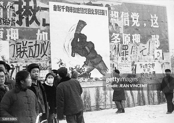 Small group of Chinese youths walk past several dazibaos, the revolutionary placards, in February 1967 in downtown Beijing, during the "Great...