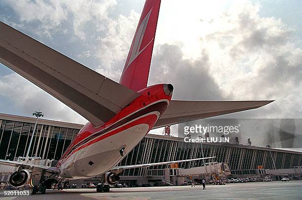 General view of a parked Shanghai Airlines airplane at a terminal during the opening of Shanghai's new Pudong International Airport 16 September...
