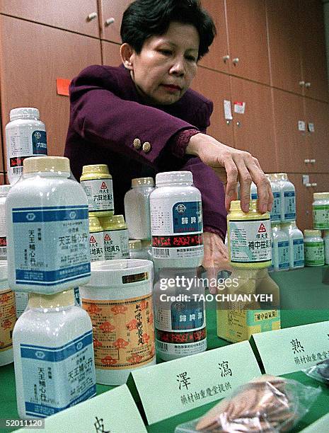 Taiwanese health official displays various Chinese herbal medicines which the authorities have proved to be effective in preventing Alzheimer's...