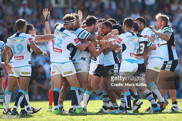 Players scuffle as David Shillington of the Titans and Ben Barba of the Sharks exchange heatd words during the round six NRL match between the...