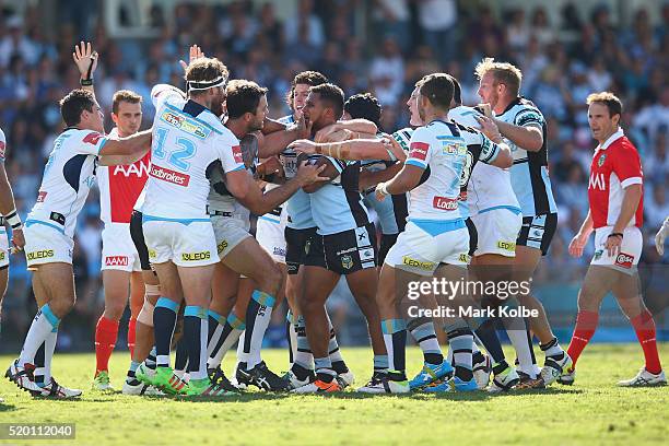 Players scuffle as David Shillington of the Titans and Ben Barba of the Sharks exchange heatd words during the round six NRL match between the...