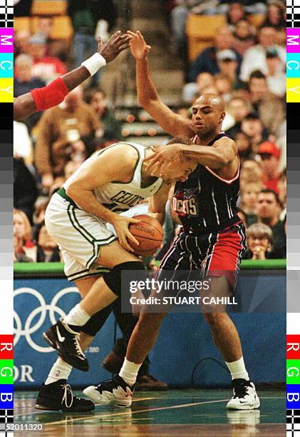 Boston Celtic Dino Radja puts his head down and drives into Houston Rocket Charles Barkley during first quarter action in Boston, Masachussetts, 29...