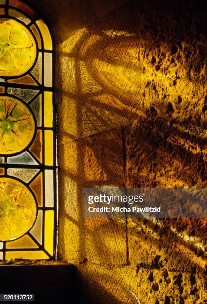 light falling through stained-glass window in church - sun rays through window stock pictures, royalty-free photos & images