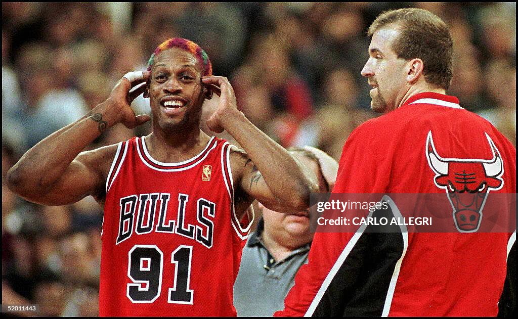 Chicago Bull Dennis Rodman(L) reacts to being thro