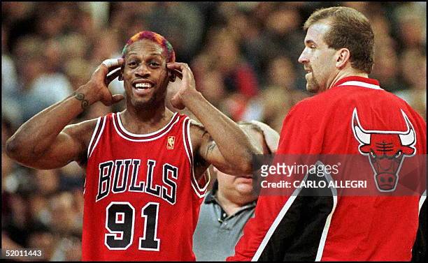 Chicago Bull Dennis Rodman reacts to being thrown out of the game after a second technical foul was called against him as Bill Wennington looks on at...
