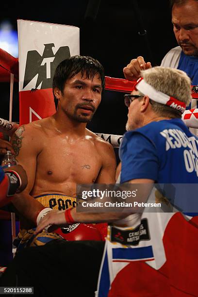 Manny Pacquiao sits in his corner with trainer Freddie Roach between rounds of their welterweight championship fight against Manny Pacquiao on April...