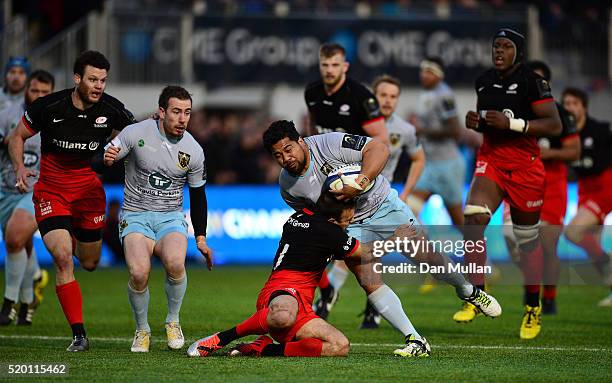 Campese Ma'afu of Northampton Saints fends off Neil de Kock of Saracens during the European Rugby Champions Cup Quarter Final between Saracens and...