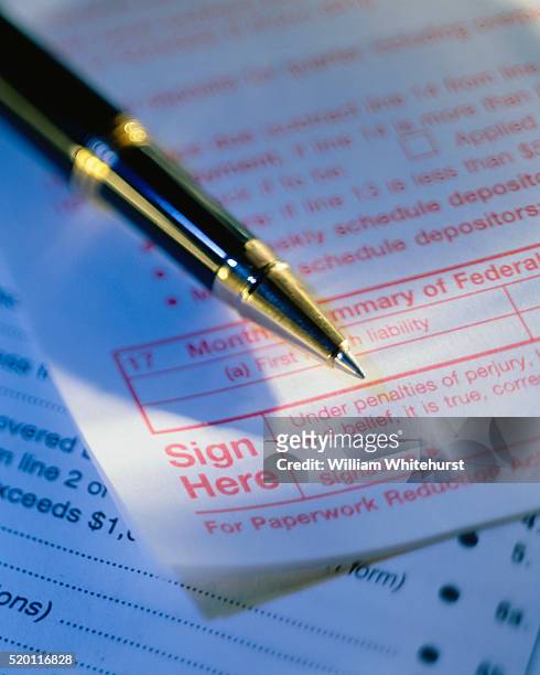 pen lying on tax form - ballpoint pen stock pictures, royalty-free photos & images