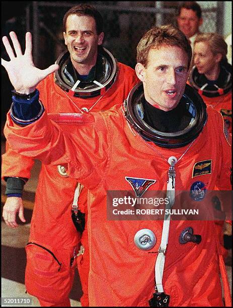 Space Shuttle Atlantis crewmember Jerry Linenger waves to wellwishers 12 January as he leaves the crew quarters at Kennedy Space Center for the ride...