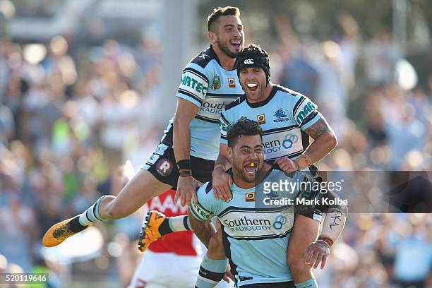 Jack Bird, Michael Ennis and Andrew Fifita of the Sharks celebrate Andrew Fifita scoring a try during the round six NRL match between the Cronulla...