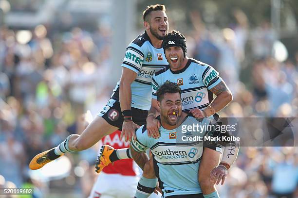 Jack Bird, Michael Ennis and Andrew Fifita of the Sharks celebrate Andrew Fifita scoring a try during the round six NRL match between the Cronulla...
