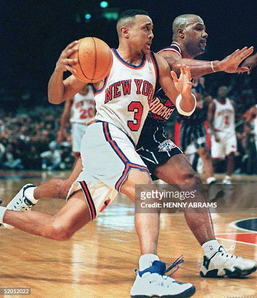 New York Knicks' John Starks drives past the Houston Rockets' Mario Elie to the basket in the first quarter at Madison Square Garden 04 February in...