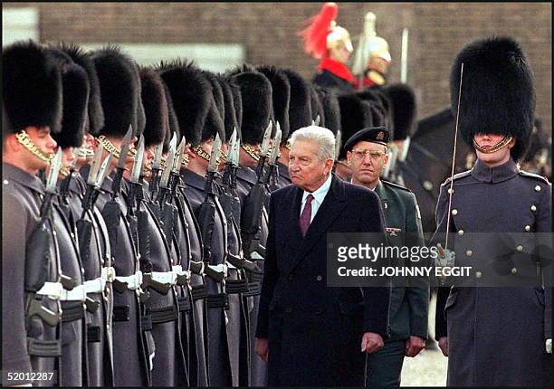 Ezer Weizman, the first Israeli president to make a state visit to Britain, inspects a guard of honour 25 February upon arrival at Horse Guards...