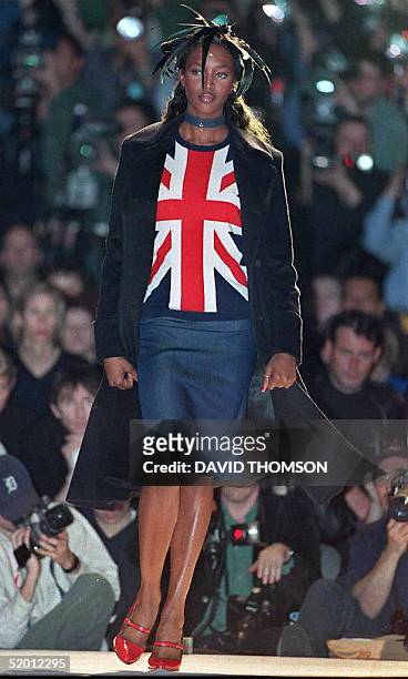 Naomi Campbell models a Union Jack shirt with a blue skirt and jacket 25 February by designer Clements Riberio at London Fashion Week.