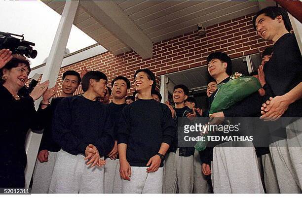 Chinese refugees, just released from the York, Pa, county jail, are applauded by their sponsors and the media in Loganville, Pa, 26 February. The 39...