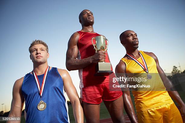 athletes at an award ceremony - medalist stock pictures, royalty-free photos & images