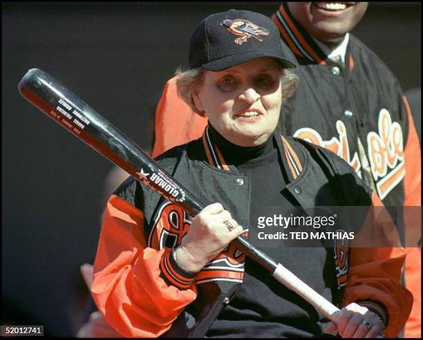 Secretary of State Madeleine Albright holds a bat before throwing out the first pitch before the game between the Kansas City Royals and the...