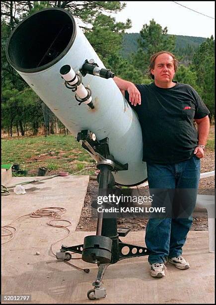 Astronomer Alan Hale poses 03 April next to the telescope that he used to discover the Hale-Bopp comet. Hale along with Thomas Bopp discovered the...