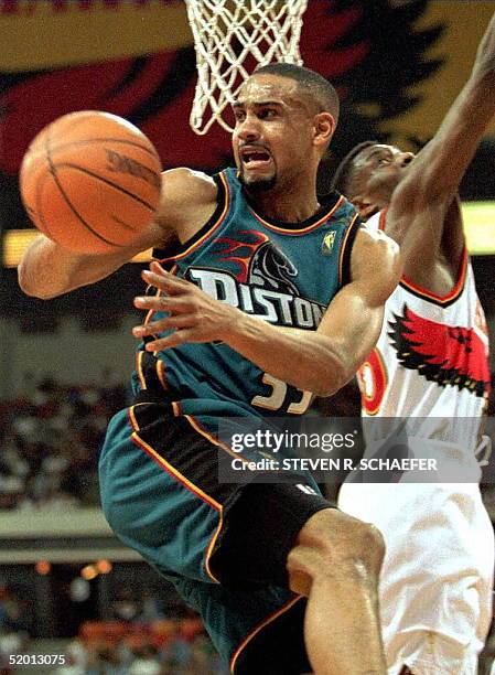 Grant Hill of the Detroit Pistons grabs a rebound away from Atlanta Hawks player Steve Smith during the fifth and deciding game of their first-round...