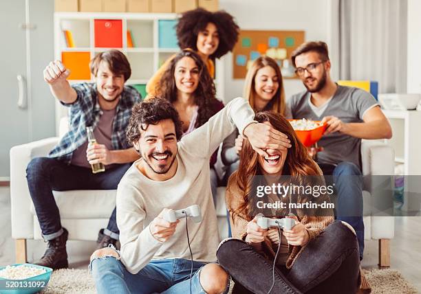 colleagues playing video games in the office relax room - ice breaking stock pictures, royalty-free photos & images