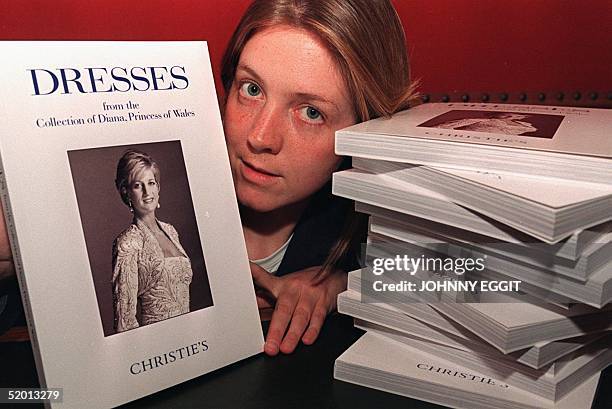 Member of Christie's auction rooms shows the catalogue of Diana's, Princess of Wales, dresses 21 May in London which are auctioned off for charity....