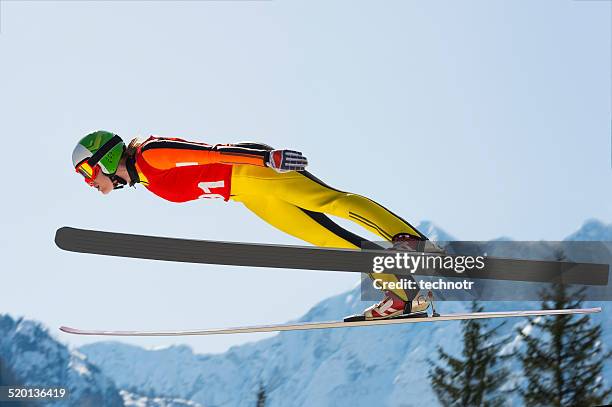 young women  in ski jumping action - ski jump stock pictures, royalty-free photos & images