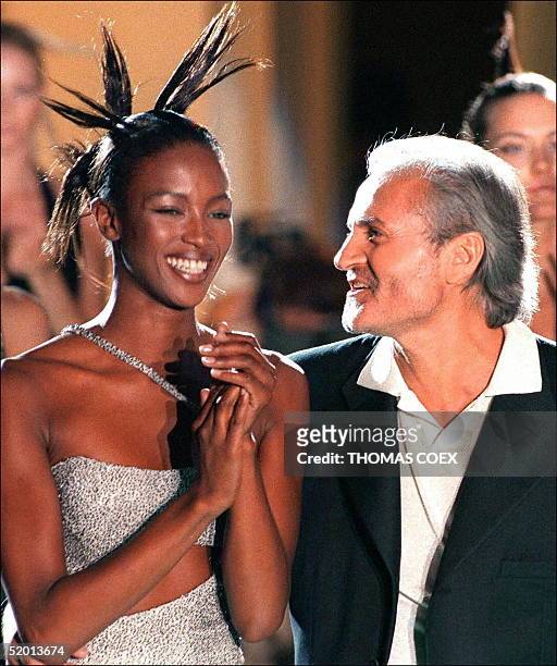 File photo dated 08 March 96 showing Italian fashion designer Gianni Versace with top model Naomi Campbell during the presentation of the...