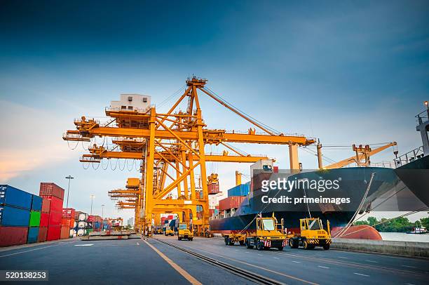 container ship in the harbor in asia , - construction cranes stockfoto's en -beelden