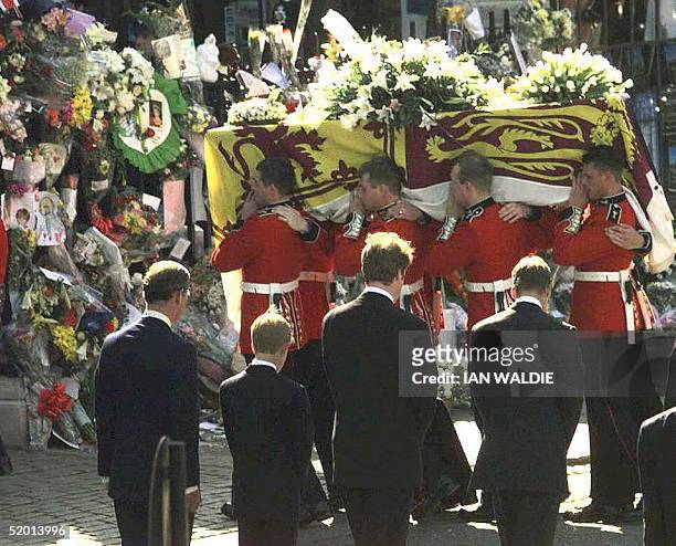 Casket bearing the body of Princess Diana is taken into Westminster Abbey, 06 September in London. Standing with backs to camera foreground are from...
