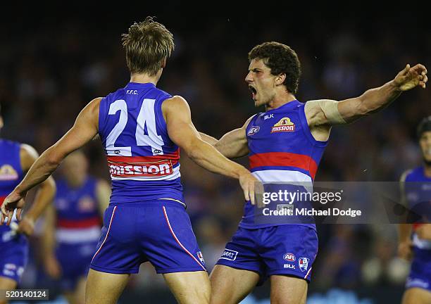 Shane Biggs of the Bulldogs celebrates a goal with Tom Liberatore of the Bulldogs during the round three AFL match between the Western Bulldogs and...