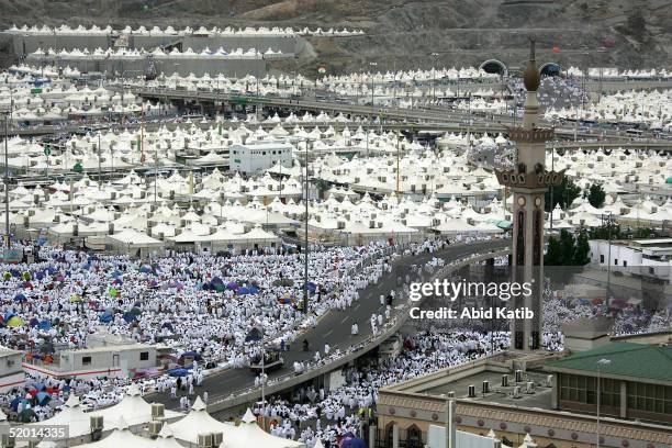 Muslim pilgrims walk amongst thousands of tents set up near a mosque which is located approximately three kilometres southeast of Mecca January 18,...