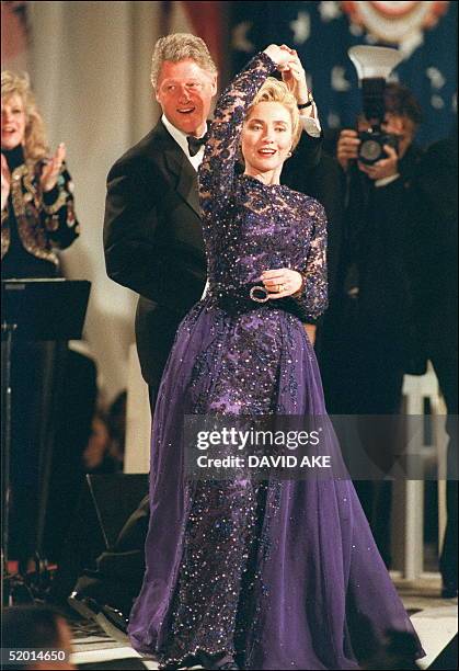 President Bill Clinton in a picture taken 20 January 1993 in Washington, DC, holds First Lady Hillary Clinton during an on stage dance as they...