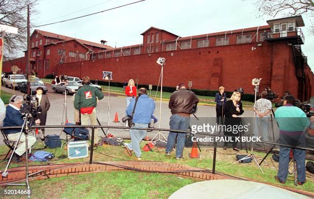 Television reporters and cameramen prepare for live reports outside the Huntsville Unit in Huntsville, Texas, 02 February. Death-row inmate Karla...