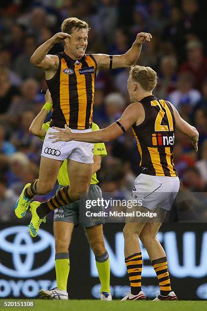 Sam Mitchell of the Hawks and James Sicily celebrate the win on the final siren during the round three AFL match between the Western Bulldogs and the...