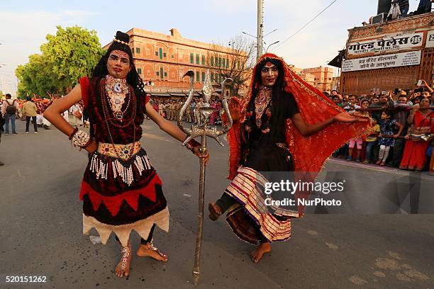 Dressed up artists as hindu Lord Shiva and goddess Kali during the traditional 'Gangaur' procession on the occasion of Gangaur Festival in Jaipur ,...