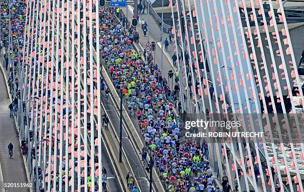 Participants run on the Erasmus bridge during the Rotterdam Marathon in Rotterdam, on April 10, 2016. / AFP / ANP / Robin Utrecht / Netherlands OUT