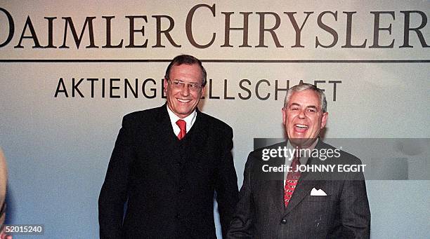 Daimler-Benz chairman Juergen Schrempp and Chrysler chairman Robert Eaton joke before giving a press conference 07 May. They announced that the...