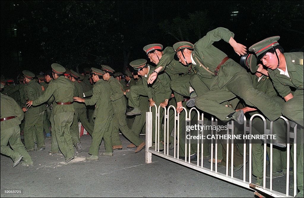 People Liberation Army (PLA) soldiers leap over a
