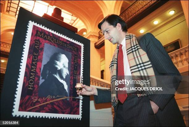 Thibault de Sade , descendant and lookalike of the infamous Marquis de Sade, drinks a cup of champagne in front of a portrait of his ancestor, the...