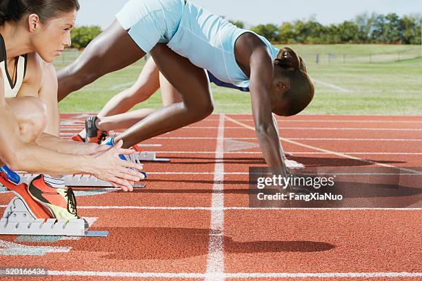 runners in starting blocks - relay race start line stock pictures, royalty-free photos & images