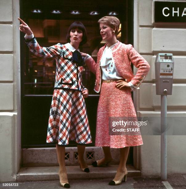 Models display 24 January 1977 in Paris : left, checked blue red and white woolen suit embroidered with a white cotton blouse with Claudine neck. At...