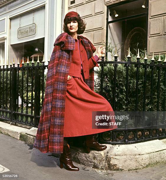 Model displays a violet, pink and burgundy tartan wool cape, burgundy tweed suit and a violet crepe de Chine blouse, 22 July 1977 in Paris for...