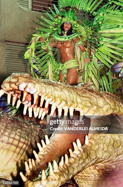 Brazilian samba dancer performs over the head of a alligator over a float symbolizing the Amazon, during the presentation of Mocidade Independente de...