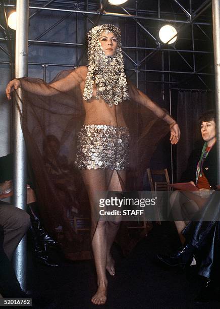 Model displays 21 January 1970 in Paris a mini-skirt in aluminium sequins worn under a caramel-shade chiffon maxi-cape, Kabyle-style headgear in...