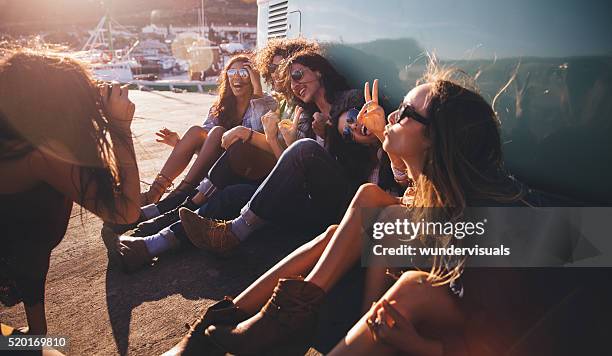 road trip hipster friends showing peace sign while taking picture - camera boat stock pictures, royalty-free photos & images