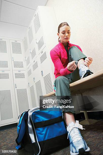 woman in a locker room - sporttas stockfoto's en -beelden